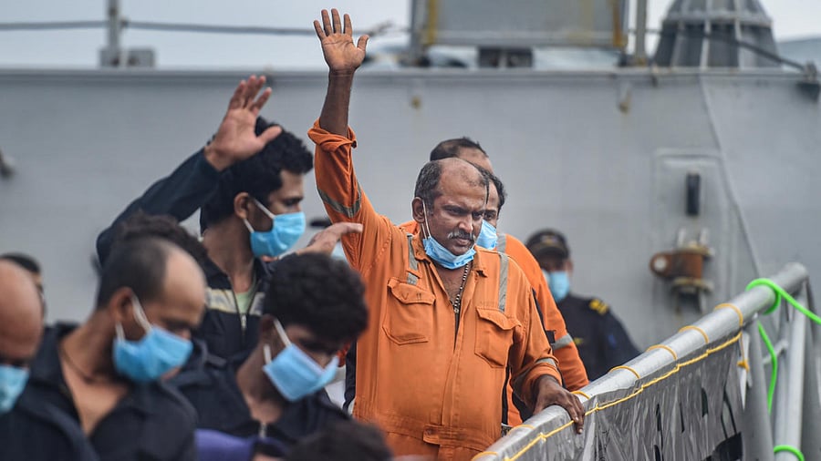Rescued crew members of barge P305 after they were brought by INS Kochi at Mumbai Naval Dockyard, in Mumbai. Credit: PTI Photo