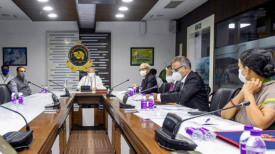 Prime Minister Narendra Modi with Gujarat CM Vijay Rupani (L) holds a review meeting with the officials to assess the damage caused by Cyclone Tauktae, in Ahmedabad, May 19, 2021. Credit: PIB/PTI Photo