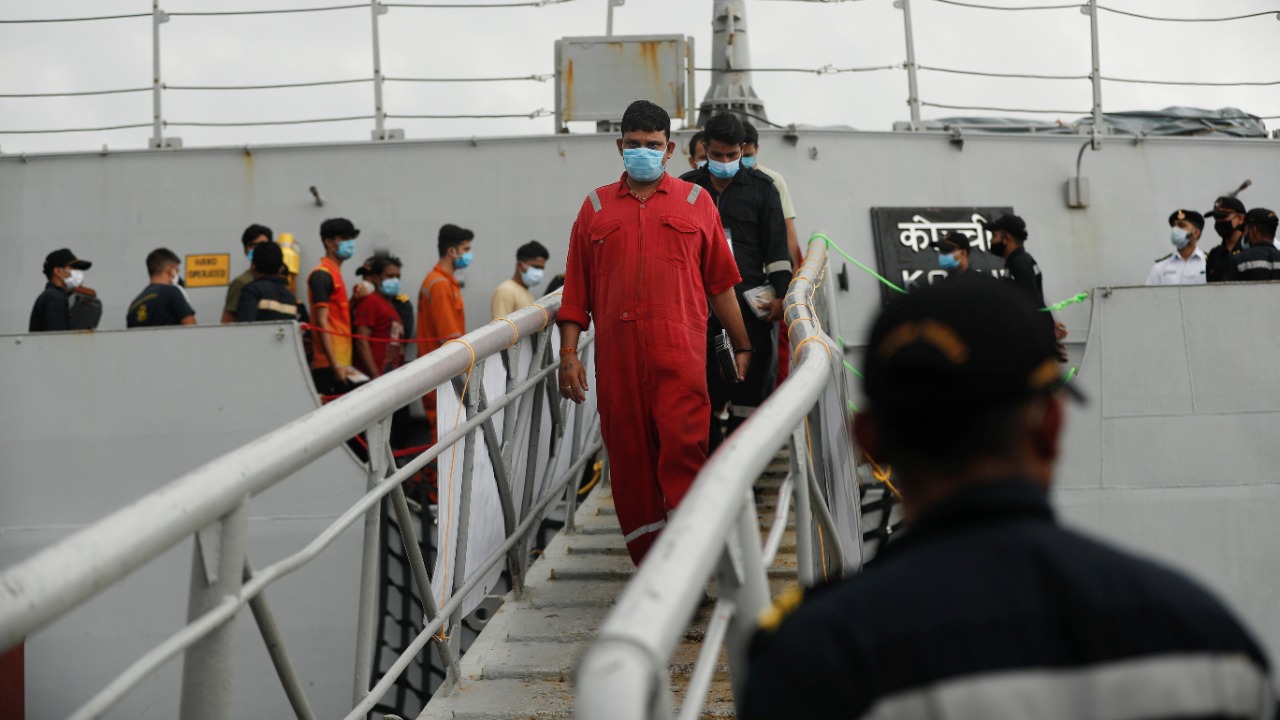 People who were stranded at sea aboard Barge P305 due to Cyclone Tauktae exit the Indian Naval Ship (INS) Kochi after they were rescued by the Indian Navy, at Naval Dockyard, Mumbai, India, May 19, 2021. Credit: Reuters Photo