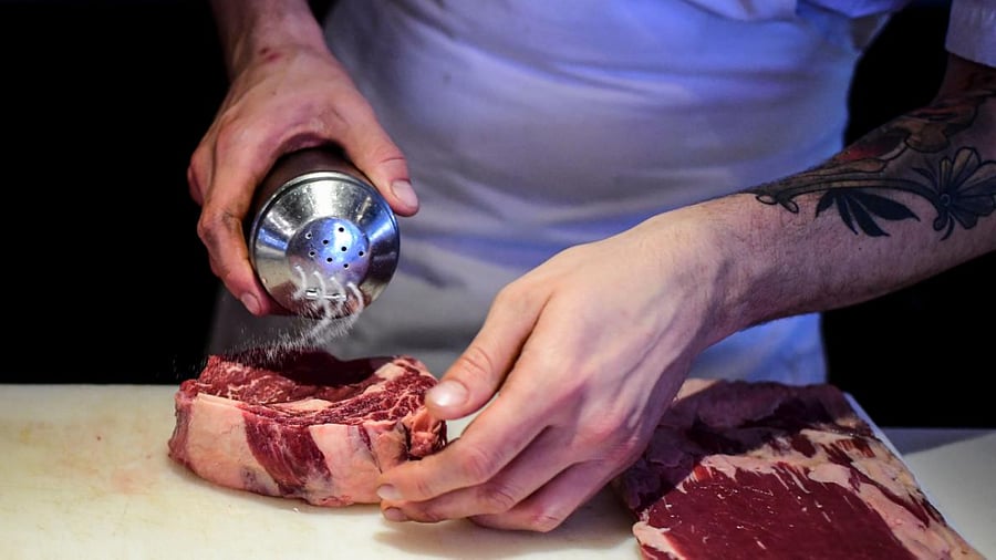 A chef prepares pieces of meat to be cooked at the kitchen of the Don Julio restaurant in Palermo neighbourhood, Buenos Aires. Credit: AFP Photo
