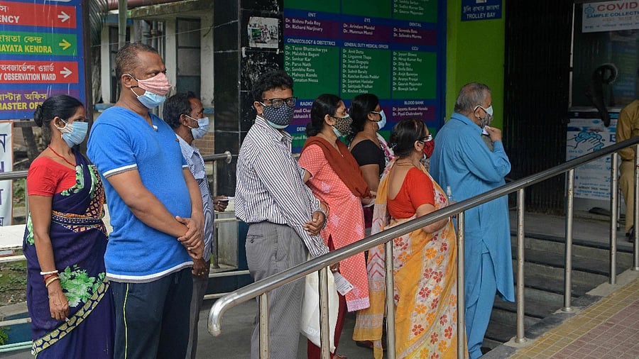 People queue up to get themselves tested for the Covid-19 coronavirus amid the 15 day partial lockdown and travel restrictions in Siliguri. Credit: AFP Photo