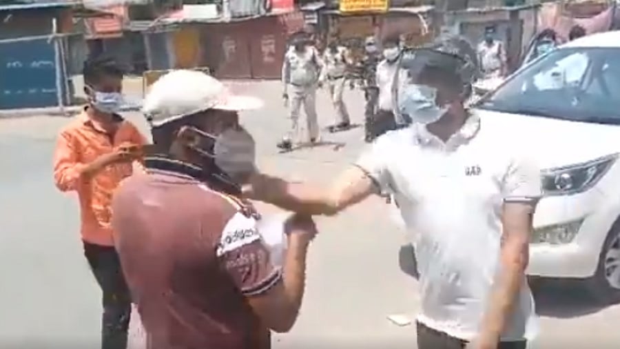 Sharma is seen slapping the man and encouraging two policemen, who rush to the spot and start hitting the man with sticks. Credit: Twitter Screengrab/@sanket