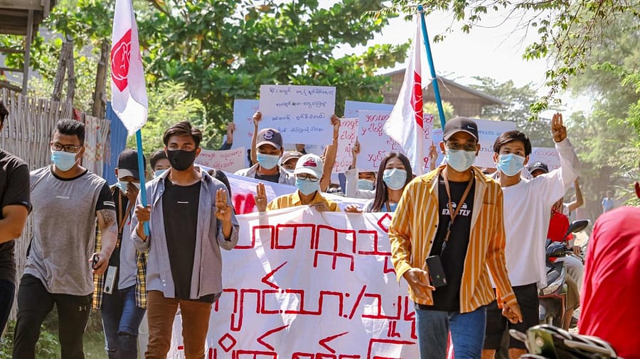 Protesters holding banners as they march during a demonstration against the military coup in Mandalay. Credit: AFP Photo