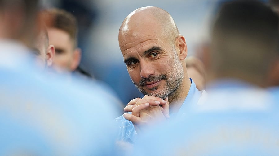 Manchester City manager Pep Guardiola celebrates after winning the Premier League. Credit: Reuters Photo