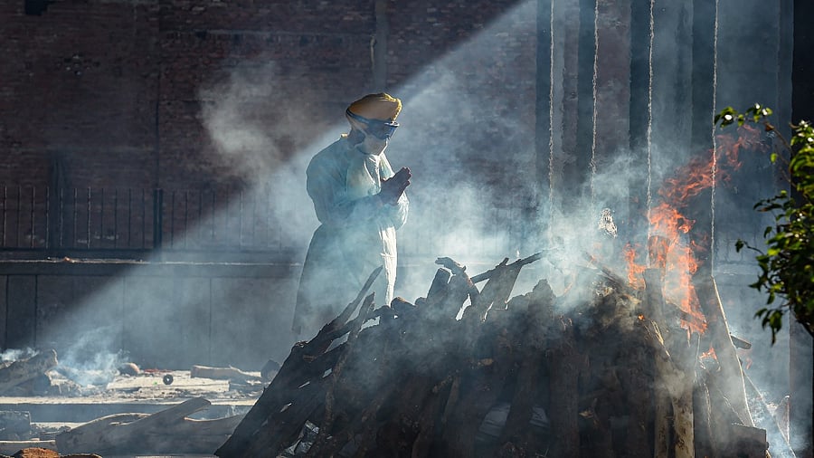 Jitender Singh Shunty of Shaheed Bhagat Singh Seva Dal performs the last rites of an unclaimed body at Seemapuri cremation ground in New Delhi. Credit: PTI Photo