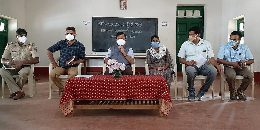 Virajpet MLA K G Bopaiah chairs the village task force committee meeting held in Kakotuparambu on Tuesday. Credit: Special arrangement