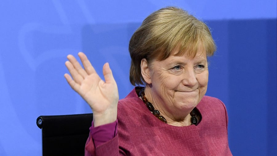 German Chancellor Angela Merkel waves to journalists at the end of a press conference following talks with Germany's state premiers on the current situation of the country's coronavirus (Covid-19) vaccination campaign, at the Chancellery in Berlin. Credit: AFP Photo