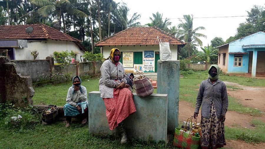 Women workers get ready to leave for coffee plantations for work in Bellaralli. Credit: DH Photo