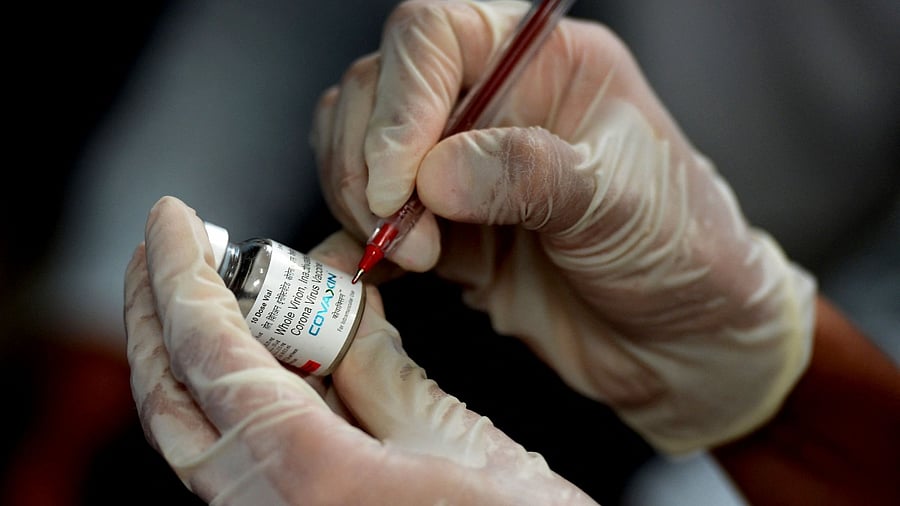 A medical worker holds a vial of Bharat Biotech's Covaxin Covid-19 vaccine. Credit: AFP Photo