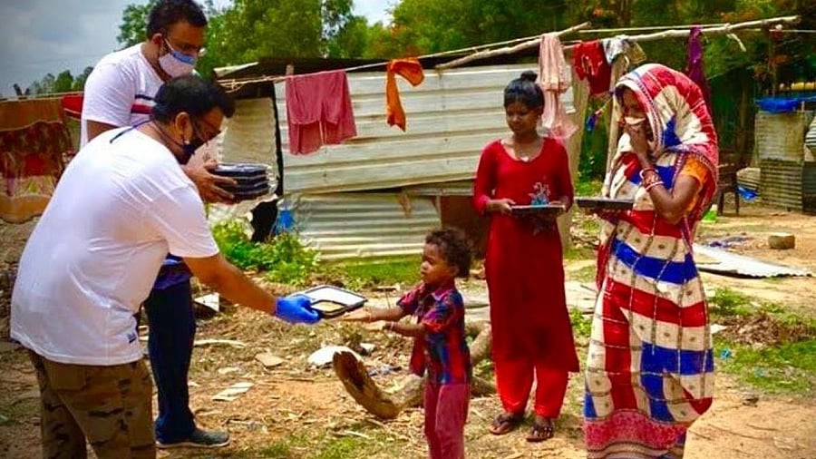 Volunteers of 'FeedOne' initiative distributing free food, sourced as part of 'Cook one extra meal in your house' initiative, to the needy and frontline workers across Bengaluru. Credit: special arrangement