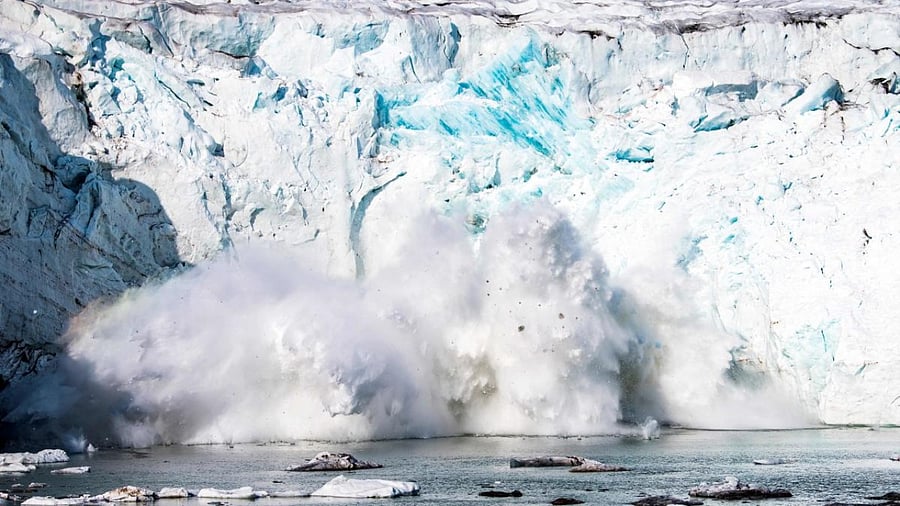 This file photo shows an iceberg calving with a mass of ice breaking away from the Apusiajik glacier, Greenland. Credit: AFP Photo