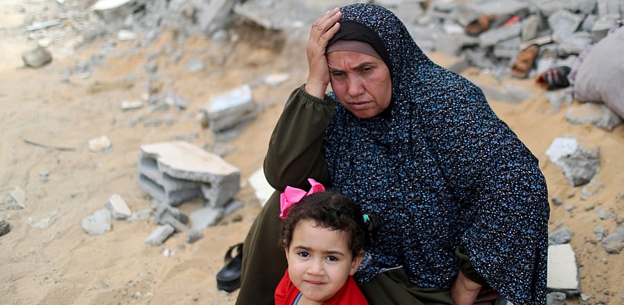 A Palestinian woman returns to her destroyed house in the Gaza strip. Credit: Reuters Photo