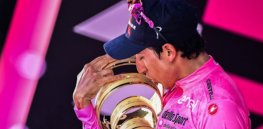 Bernal celebrates with the race's Trofeo Senza Fine (Endless Trophy). Credit: AFP Photo