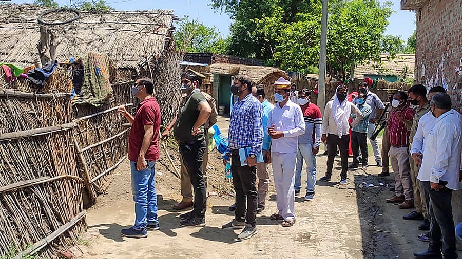 Nodal Officer Saurabh Tripathi along with officials investigates after a group of residents jumped into the Saryu River to avoid vaccination against Covid-19, in Sisoda village, in Barabanki district, Saturday, May 22, 2021. Credit: PTI Photo