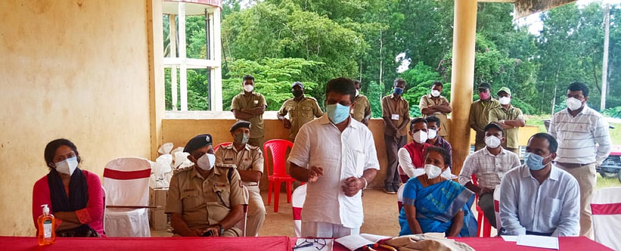 MLA M P Appachu Ranjan speaks at a village-level meeting in Suntikoppa.
