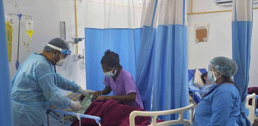 Healthcare workers tend to a Covid patient. Credit: AFP Photo