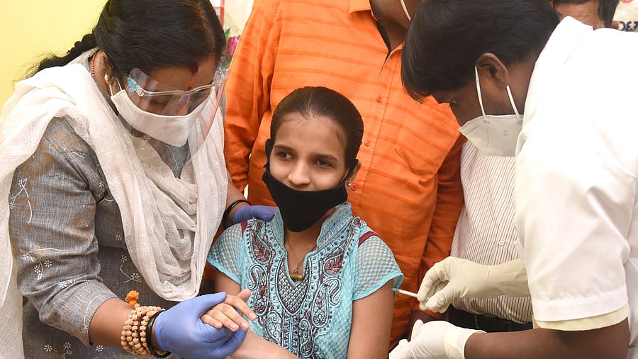 Medical staff administers Covid vaccine for a visually challenged person during a Covid vaccination drive. Credit: DH Photo