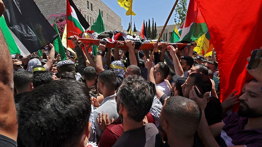Relatives of Palestinian Birzeit University student Fadi Wahha, who was reportedly shot by Israeli security forces during a protest, carry his body during his burial in Birzeit, about 11 kilometres north of Ramallah in the West Bank, on June 3, 2021. Credit: AFP Photo