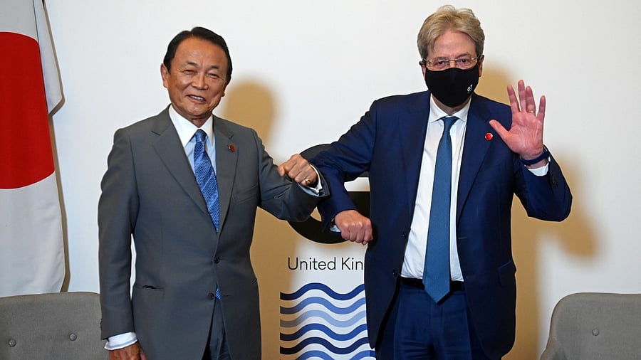 Japan's Finance Minister Taro Aso and European Commissioner for Economy Paolo Gentiloni pose together at a meeting of finance ministers from across the G7 nations ahead of the G7 leaders' summit, at Lancaster House in London, Britain June 4, 2021. Credit: Reuters Photo