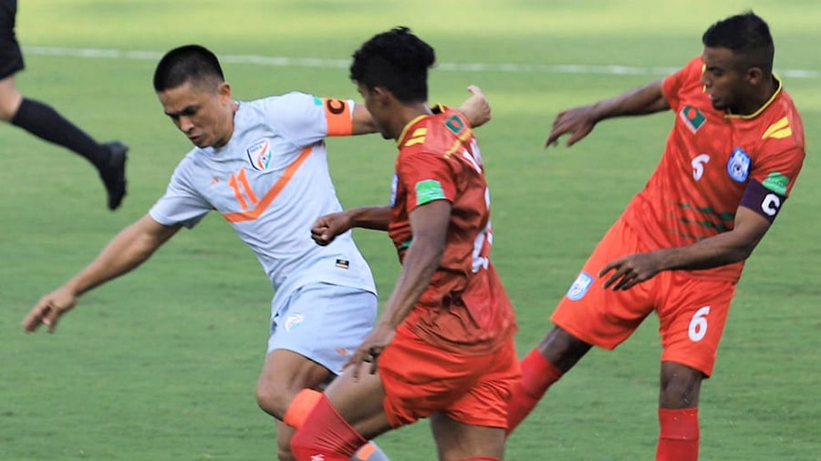 Indian football team captain Sunil Chhetri in action against Bangladeshi players during their World Cup qualifier match held in Qatar. Credit: PTI Photo