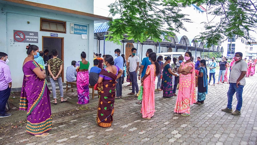 People wait for their Covid-19 test, outside a healthcare center in Nagaon district. Credit: PTI Photo