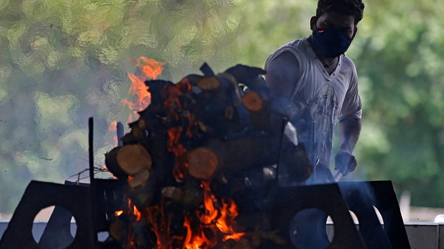 A man cremates his relative who died from the coronavirus at a crematorium in Ahmedabad, India, June 10, 2021. Credit: Reuters Photo