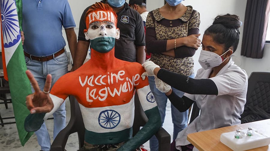 Rajkumar Haryani who painted his body to create awareness about vaccination, receives a dose of Covid-19 vaccine, in Ahmedabad. Credit: PTI Photo