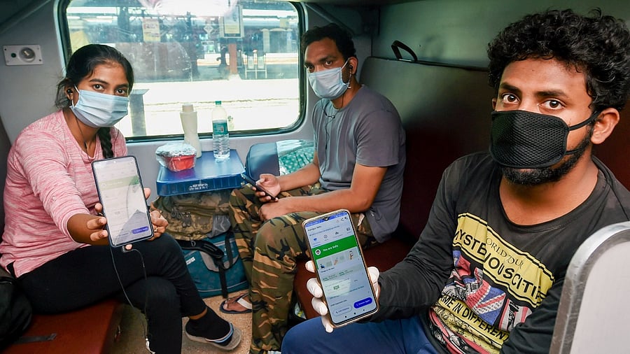 People show Arogya Setu App installed in their phones while travelling by special New Delhi-Bilaspur train from New Delhi Railway Station. Credit: PTI File Photo