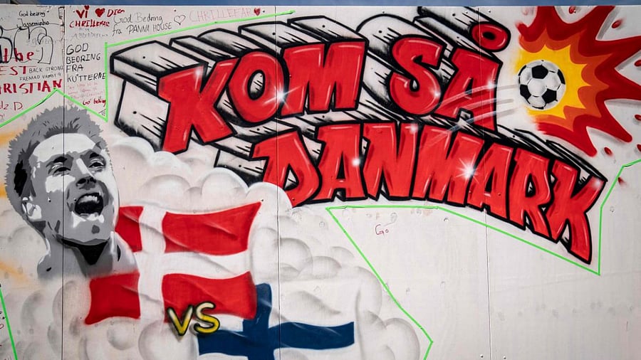 A mural with a portrait of Christian Eriksen reads 'Come on, Denmark' on the wall of the Football Village at Ofelia Beach in Copenhagen, Denmark. Credit: AFP Photo