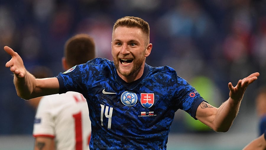 Slovakia's defender Milan Skriniar celebrates scoring the team's second goal during the Euro 2020 Group E football match between Poland and Slovakia. Credit: AFP Photo