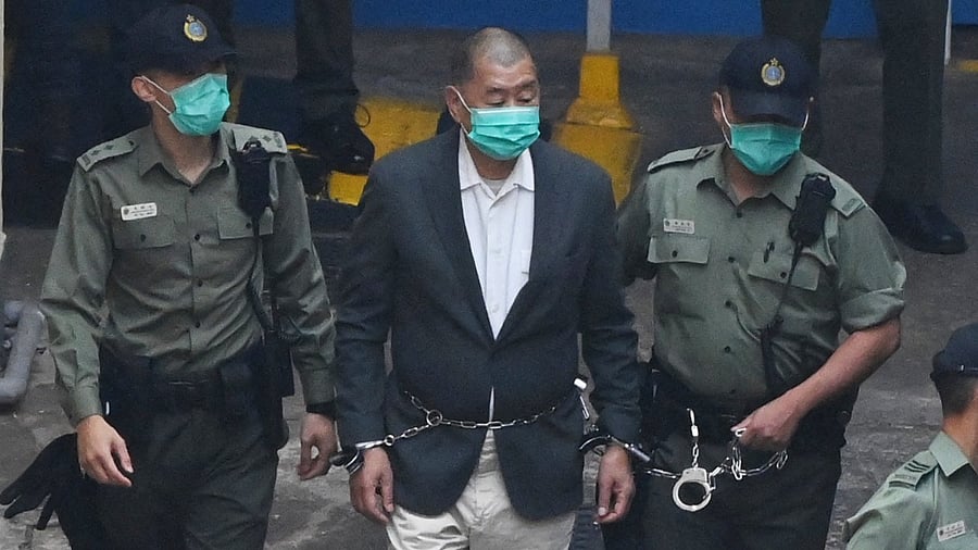 In this file picture taken on December 12, 2020, Hong Kong pro-democracy media tycoon Jimmy Lai (C) is led into a police van as he heads to court to be charged under the territory's controversial new National Security Law. Credit: AFP Photo