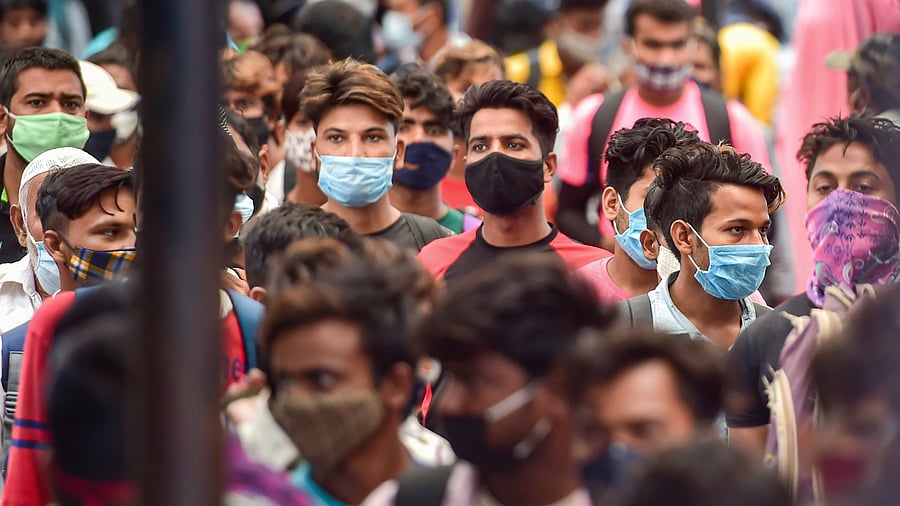 Passengers crowd at city railway station as the authorities announced the relaxation in lockdown restrictions, in Bengaluru, Monday, June 14, 2021. Credit: PTI Photo
