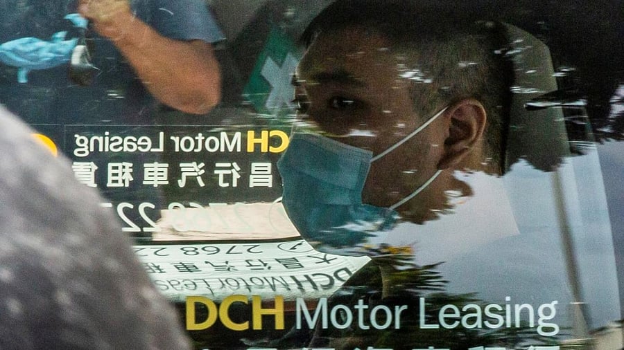 Tong Ying-kit, who is accused of deliberately driving his motorcycle into a group of police officers on July 1, 2020, arriving at the West Kowloon Court in Hong Kong. Credit: AFP Photo