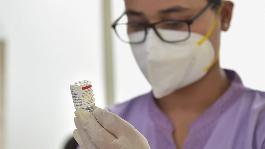 A health worker prepares to administer a dose of the 'Covaxin' vaccine. Credit: PTI Photo