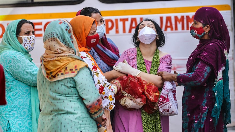 Family members of a Covid-19 victim mourn at a cremation ground in Jammu. Credit: PTI Photo