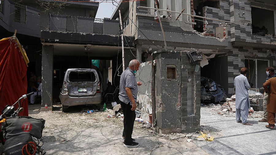 Residents examine their damaged houses at the site of a car bombing Wednesday, in Lahore, Pakistan. Credit: AP Photo