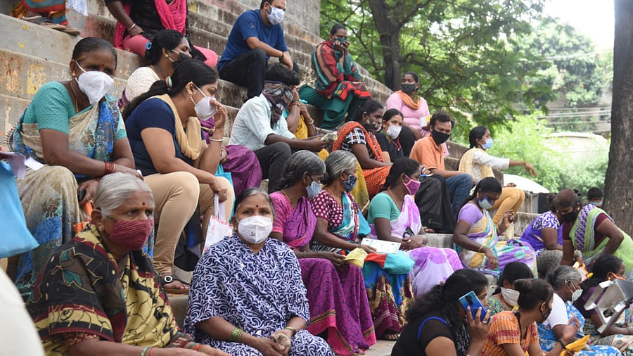 People waiting for food kit, at Covid-19 Unlock relief free food kit distribution by volunteers at Muneshwara Nagar, Girinagar in Bengaluru. Credit: DH Photo/ S K Dinesh