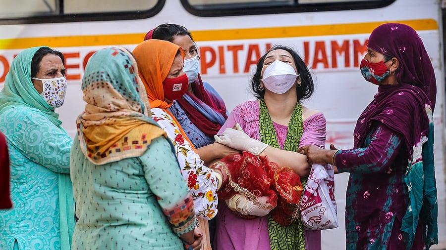 Family members of a Covid-19 victim mourn at a cremation ground in Jammu. Credit: PTI Photo
