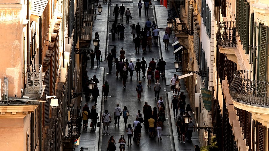 People walk along a street on the eve of Italy moving into the 'white zone'. Credit: AFP Photo