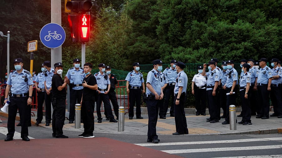 People gather before a rehearsal of a fireworks display near the National Stadium ahead of the 100th founding anniversary of the Communist Party of China in Beijing. Credit: Reuters Photo