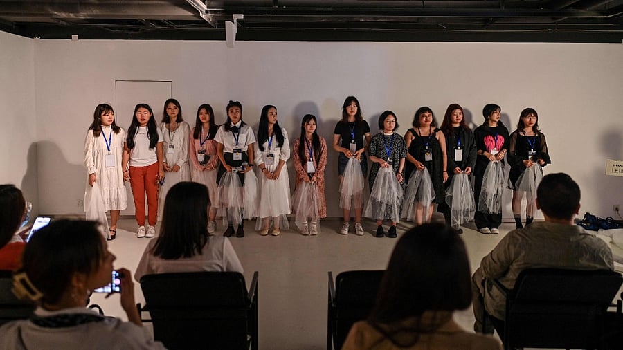 Eating disorder campaigner Zheng Qinwen (L) during the presentation of an anti body-shaming exhibition, at the Himalaya Museum in Shanghai. Credit: AFP Photo