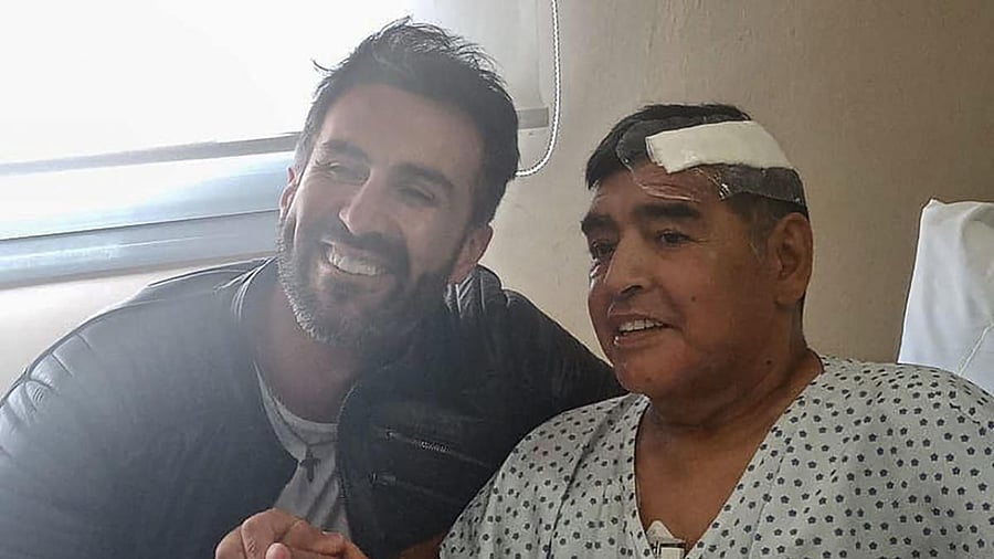 Argentine football legend Diego Maradona (R) shaking hands with his doctor Leopoldo Luque. Credit: AFP File Photo