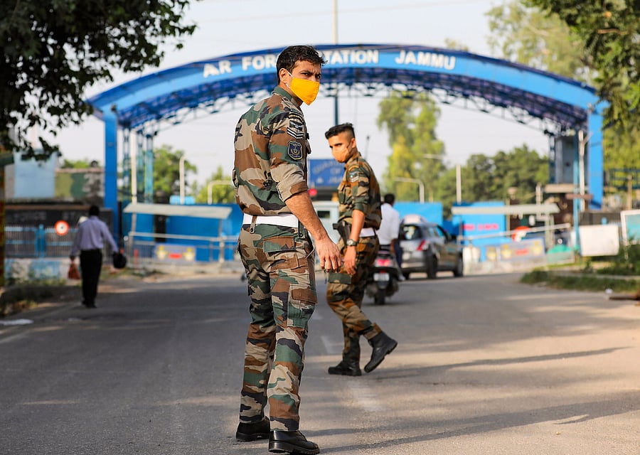 Security personnel patrol after two low intensity explosions reported in the technical area of Jammu Air Force Station in the early hours of Sunday. Credit: PTI Photo