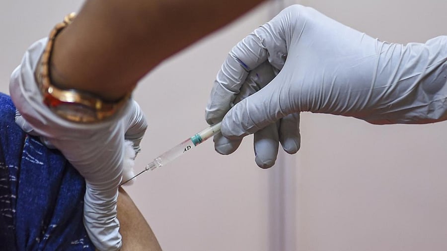  A health worker inoculates a dose of Covid-19 vaccine to a beneficiary at a vaccination centre in Mumbai. Credit: PTI Photo