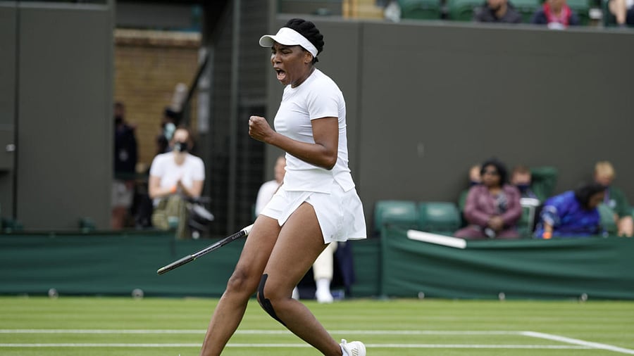 Venus Williams of the US celebrates winning the women's singles first round match against Romania's Mihaela Buzarnescu on day two of the Wimbledon Tennis Championships in London. Credit: AP Photo