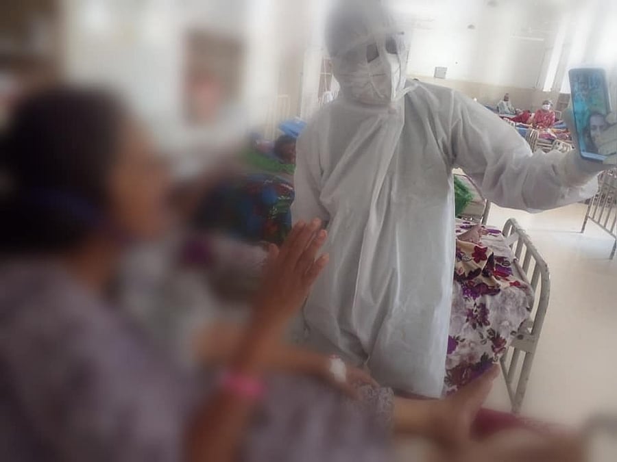 A Covid-19 patient speaks to a family member via video calling at Thiruvananthapuram Medical College Hospital . Credit: DH Photo