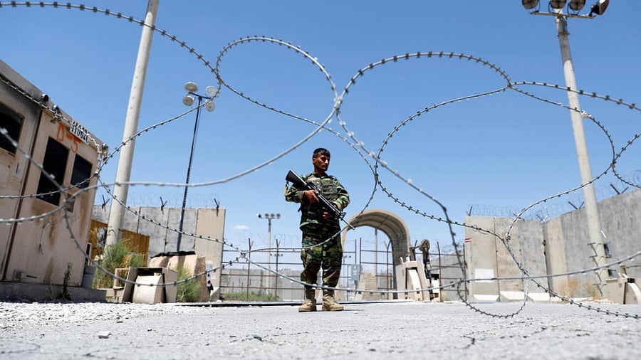 Afghan National Army soldier stands guard at Bagram U.S. air base gate on day of troop departure. Credit: Reuters Photo