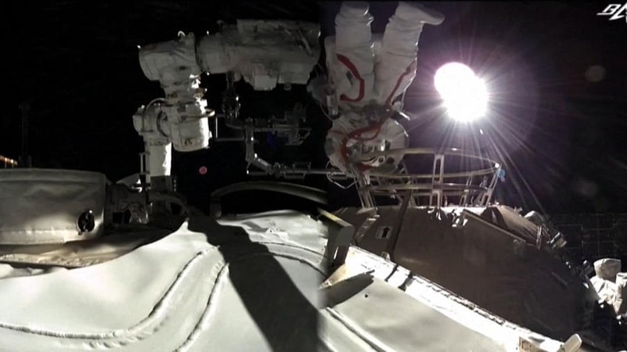 This screen grab made from video released by Chinese state broadcaster CCTV shows Chinese astronaut Liu Boming stepping outside China's new Tiangong space station in orbit around Earth. Credit: AFP/CCT V