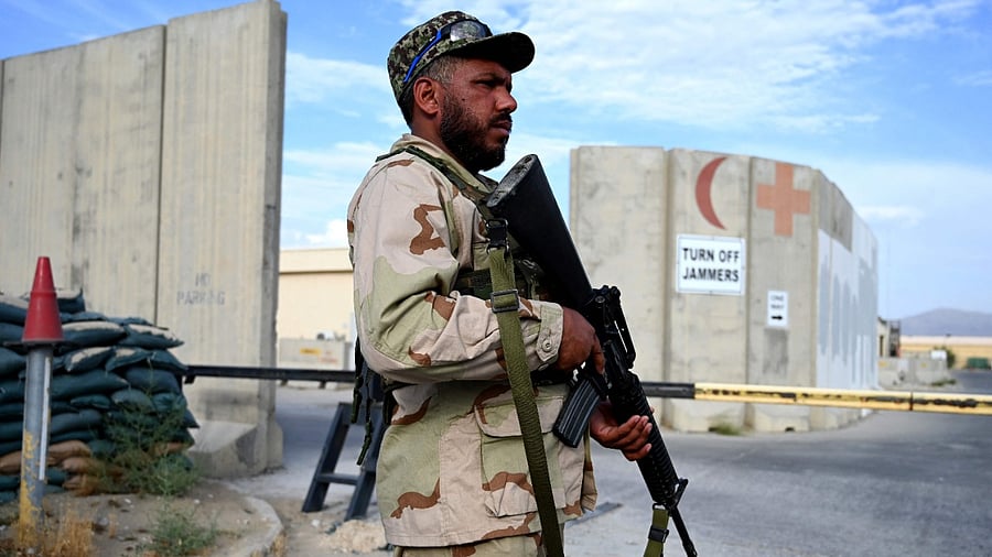 An Afghan National Army soldier stands guard at gate of a hospital inside the Bagram US air base. Credit: AFP Photo