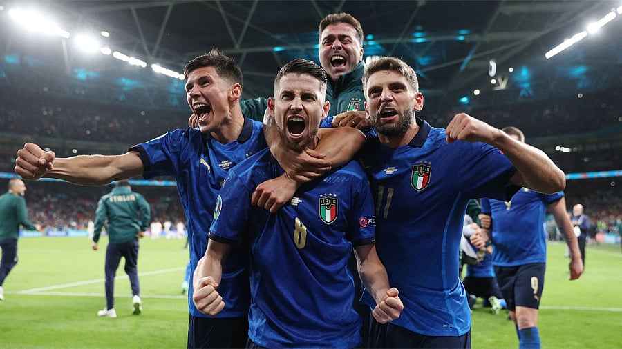  Italy's midfielder Jorginho (C) celebrates with teammates after scoring in a penalty shootout and winning the UEFA EURO 2020 semi-final football match between Italy and Spain at Wembley Stadium. Credit: AFP Photo